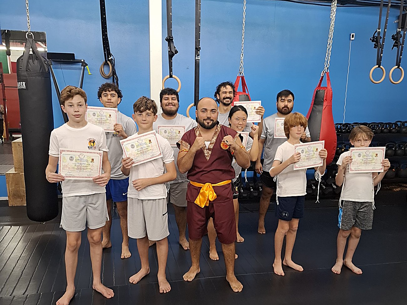 Kru Claudiu and Laguna Muay Thai students with their certificates in Port Isabel