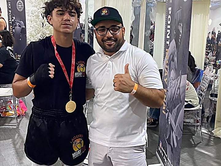 A Laguna Muay Thai member with a gold medal at an IKF Point Muay Thai event