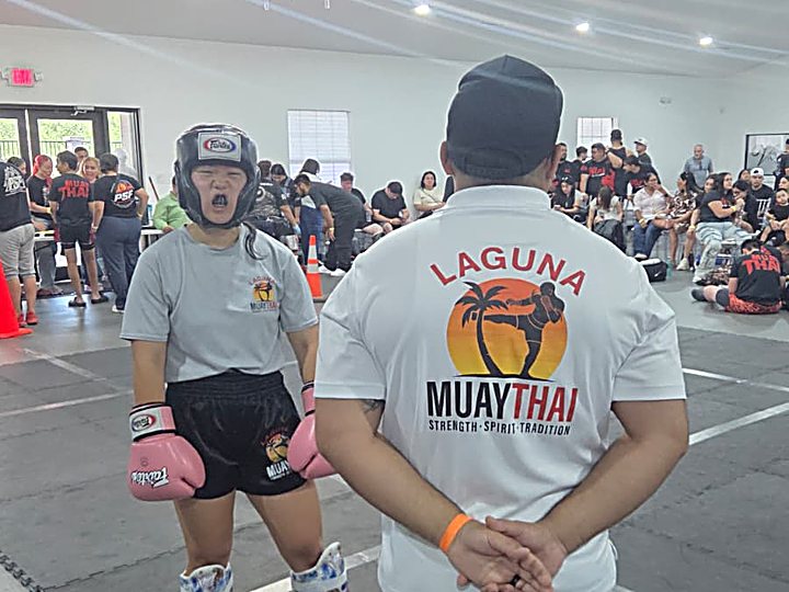 Kru Claudiu with a Laguna Muay Thai competitor at a tournament